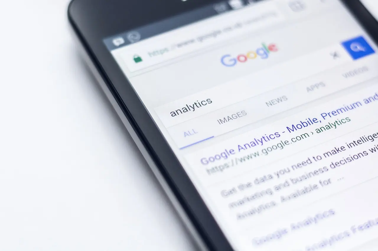 A tablet on a desk showing a Google search result for Google Analytics
